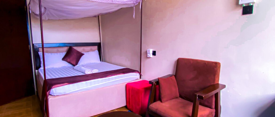 Family Ties Inn - Best Hotels and Lodges in Bagamoyo Tanzania (2026 Guide) Cozy lodge room at Family Ties Inn in Bagamoyo Tanzania with comfortable bed and warm lighting